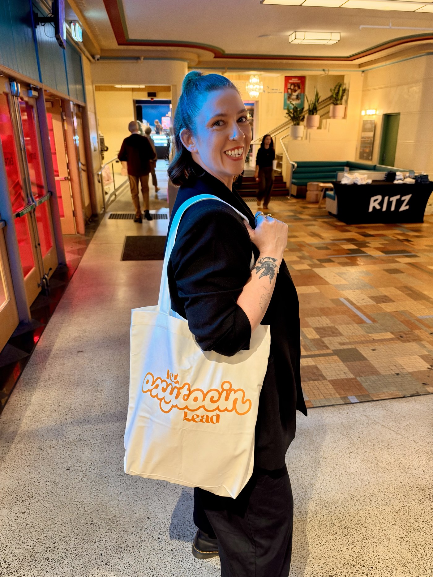 Let Oxytocin Lead canvas tote bag carried at a cinema screening